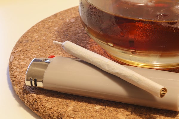 A rolled weed with a lighter and alcohol